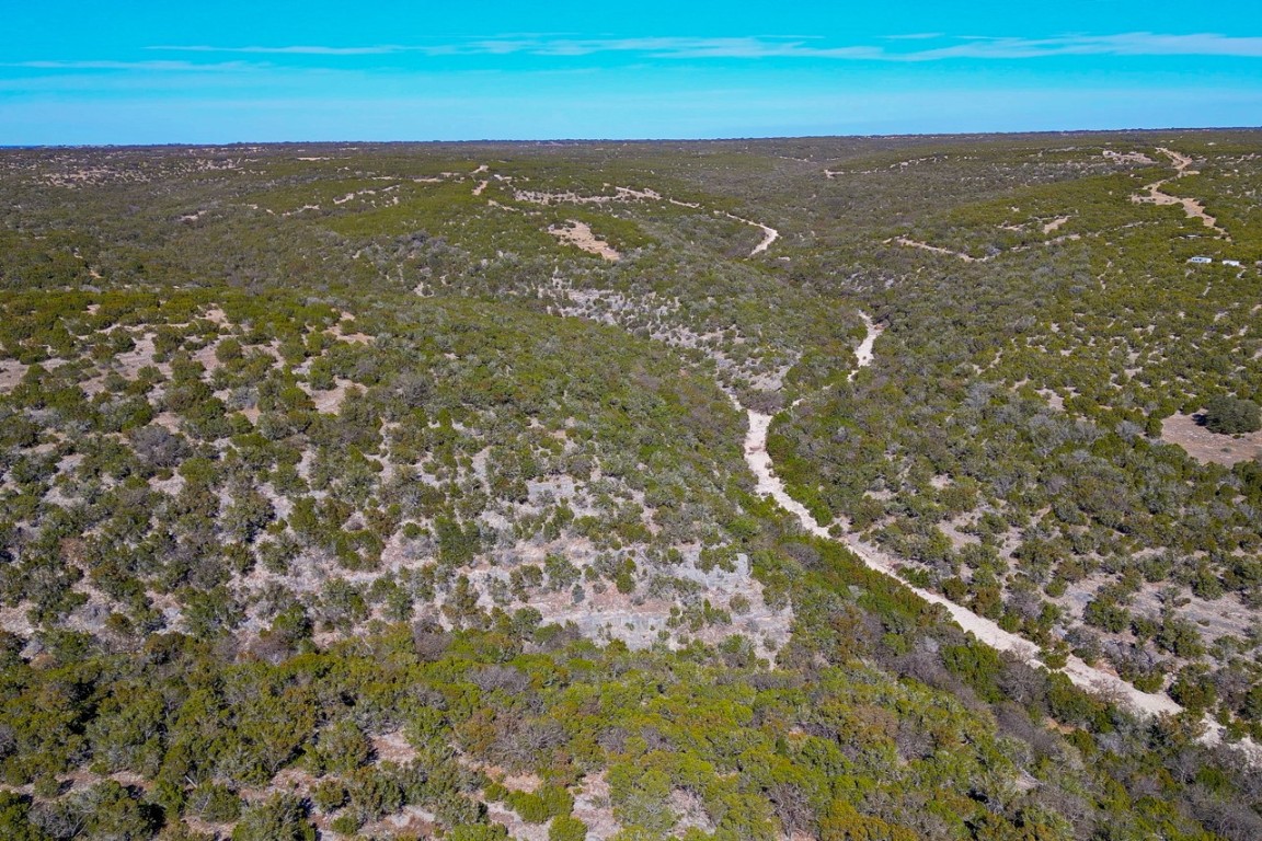 Undisclosed Address Rocksprings, TX 78880 - Photo 6 of 11 Aerial view of property and surrounding area with a heavily wooded area