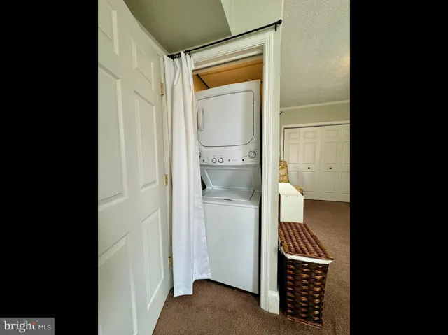 a bathroom with a walk in closet and wooden floor