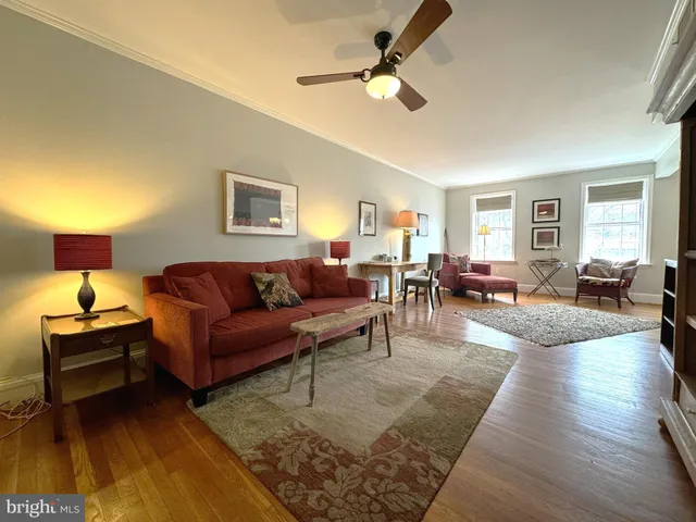 a living room with furniture and a lamp