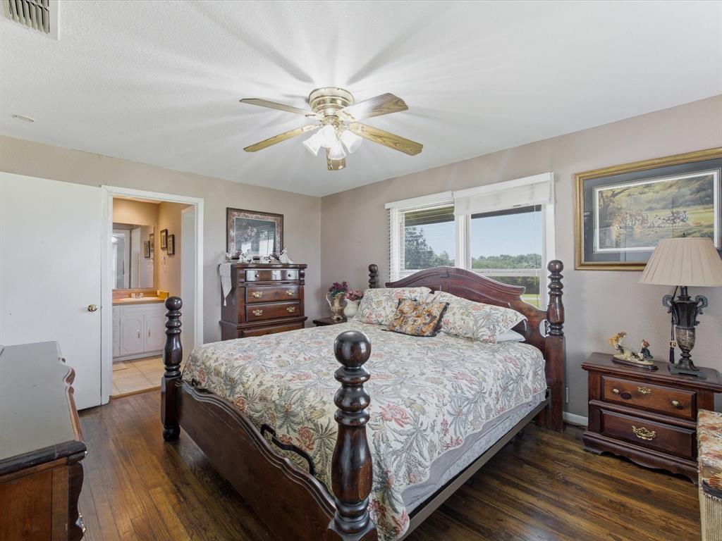 301 Ovilla Road Waxahachie, TX 75167 - Photo 24 of 38 a bedroom with a bed and wooden floor
