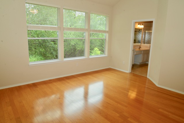 138 Chestnut Court Georgetown, TX 78633 - Photo 10 of 25 Hardwood floors and natural light elevate this inviting bedroom with a private bath entry.