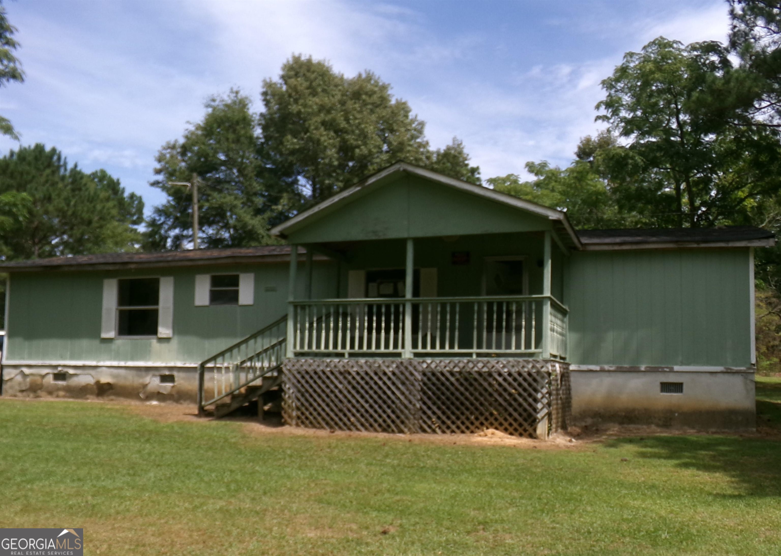 4539 Hickory Grove Church Road Mitchell, GA 30820 - Photo 1 of 1 a view of a house with a yard and a deck