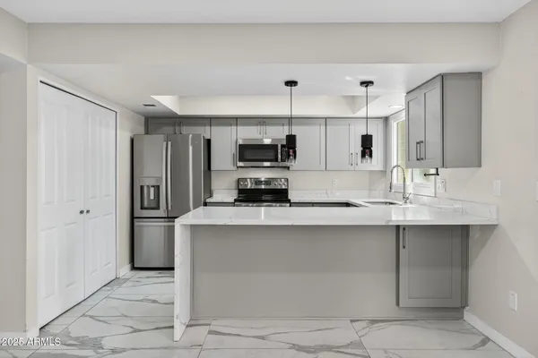 a kitchen with a sink a stove and microwave