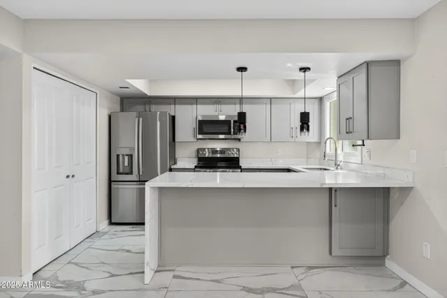 a kitchen with a sink a stove and microwave