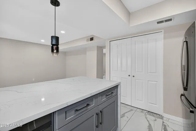 a kitchen with stainless steel appliances granite countertop a sink a stove and a refrigerator