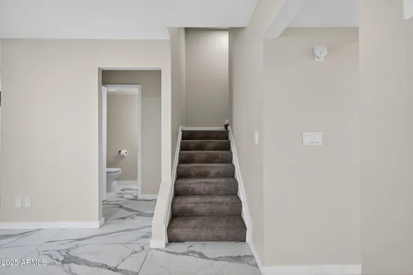 an empty room with windows and ceiling fan