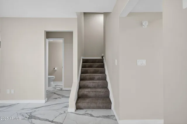 an empty room with windows and ceiling fan