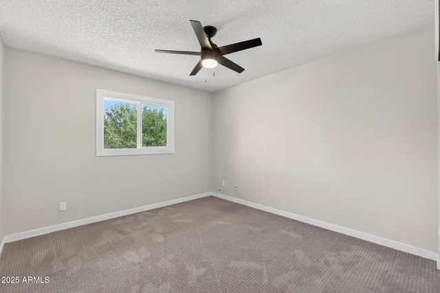 a bedroom with bed and a potted plant
