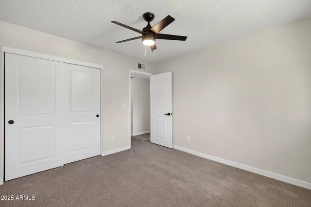 a view of a livingroom with a ceiling fan and window