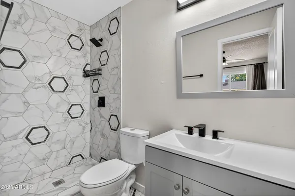 an empty room with closet and a chandelier fan