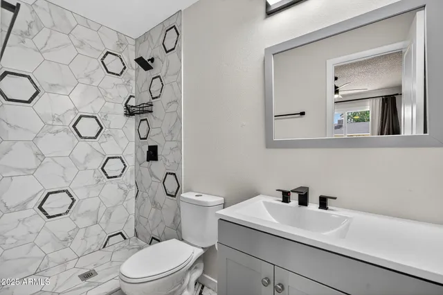 an empty room with closet and a chandelier fan