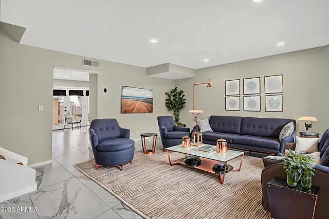 a living room with furniture and a potted plant