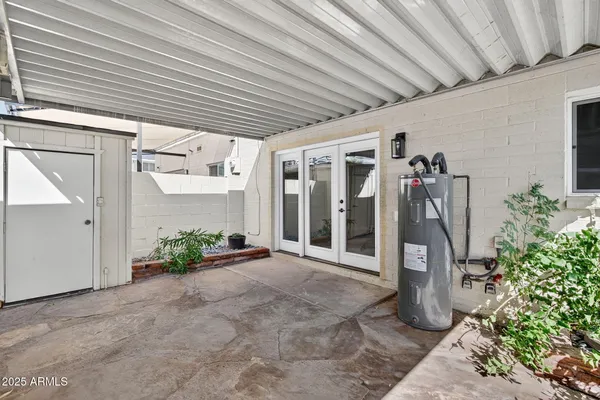 a view of a lake with a bench and trees in the background