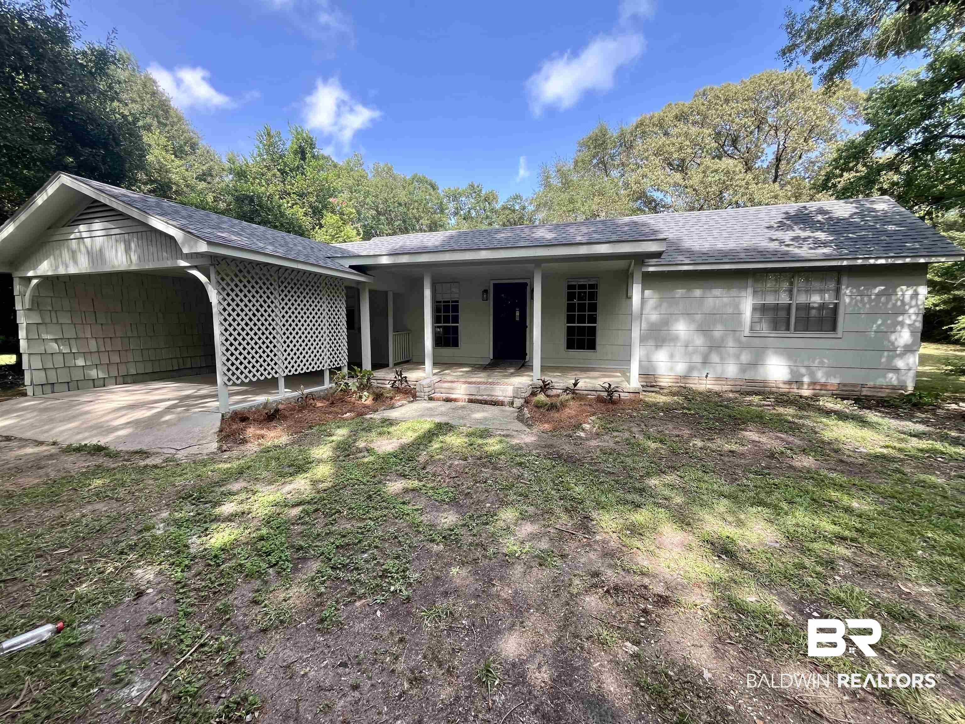 3105 Bryant Road Mobile, AL 36605 - Photo 1 of 39 Ranch-style residence featuring a covered carport with lattice detailing, a covered front entry, and a light-toned exterior