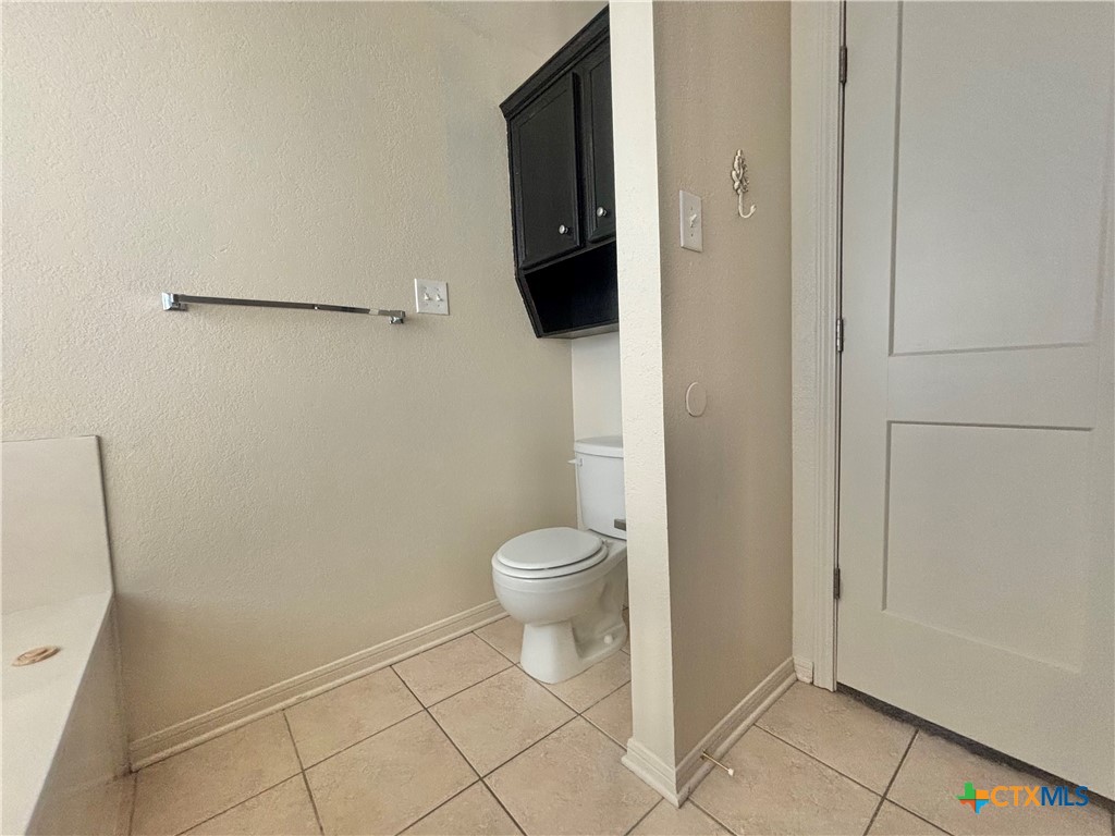 3610 Armstrong County Court Killeen, TX 76549 - Photo 14 of 29 a bathroom with a granite countertop toilet and a shower