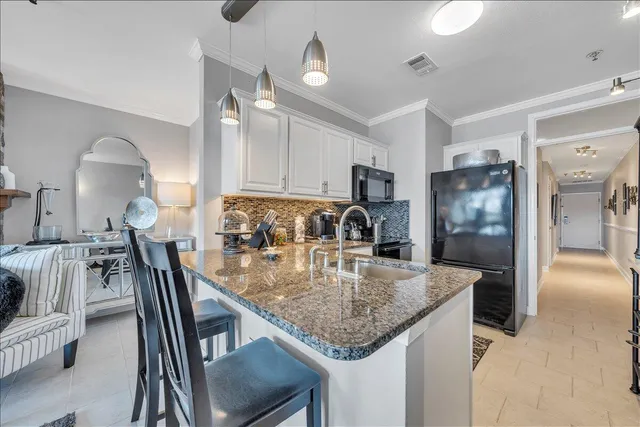 a bathroom with a granite countertop toilet and a sink