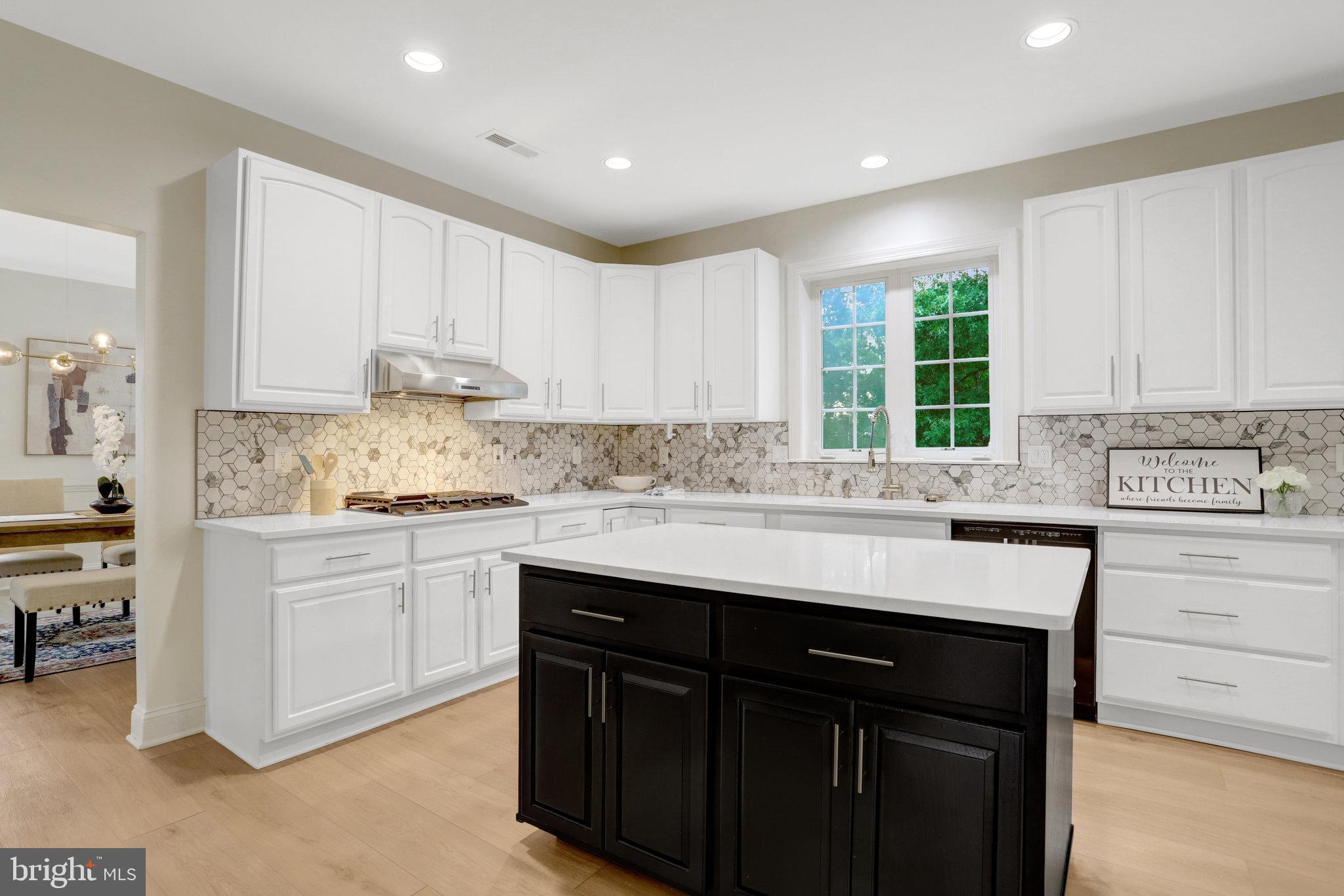 3905 Cook Street Alexandria, VA 22311 - Photo 11 of 39 a kitchen with kitchen island granite countertop a sink window and cabinets