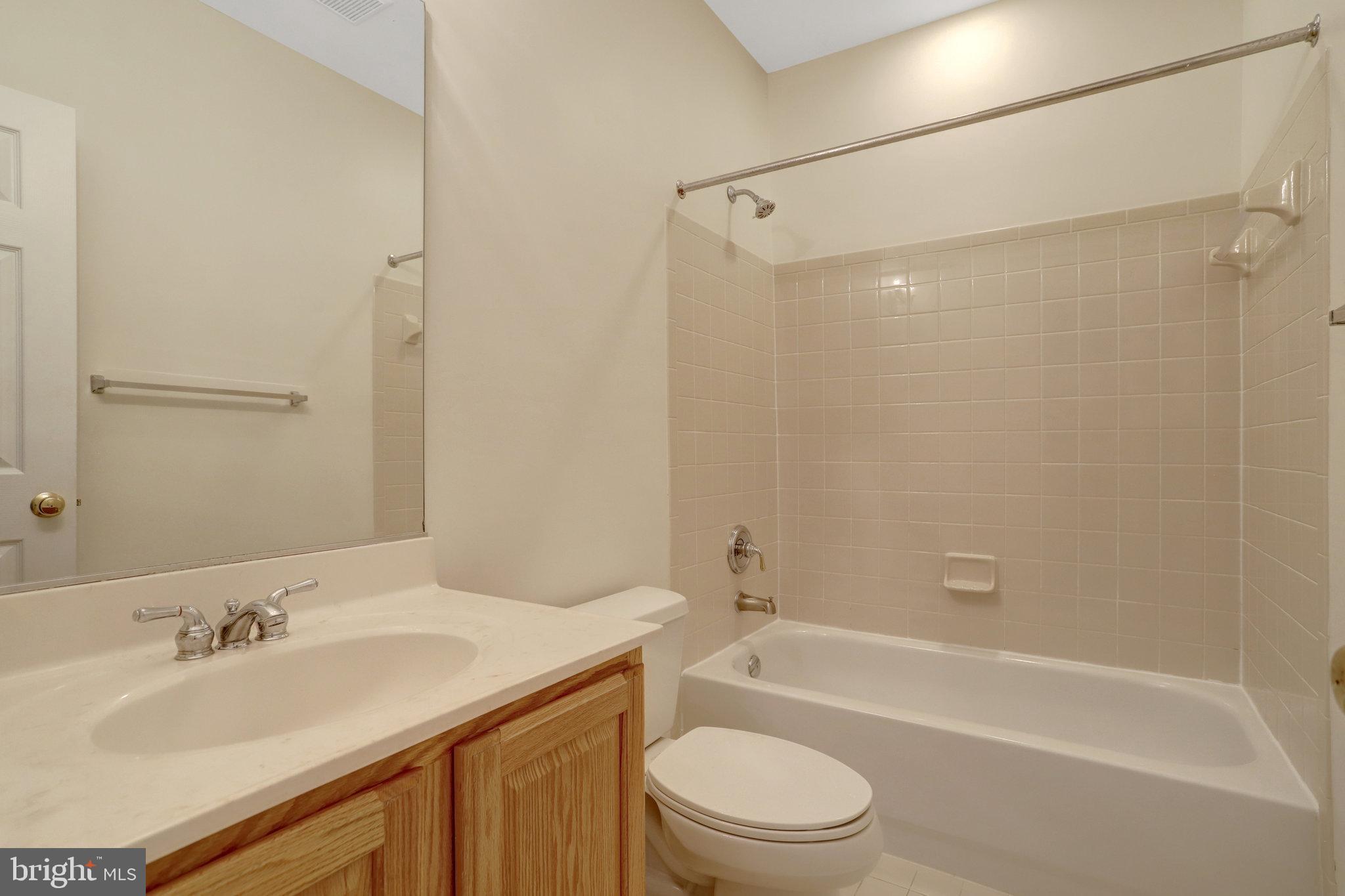 3905 Cook Street Alexandria, VA 22311 - Photo 22 of 39 a bathroom with a granite countertop sink toilet and shower