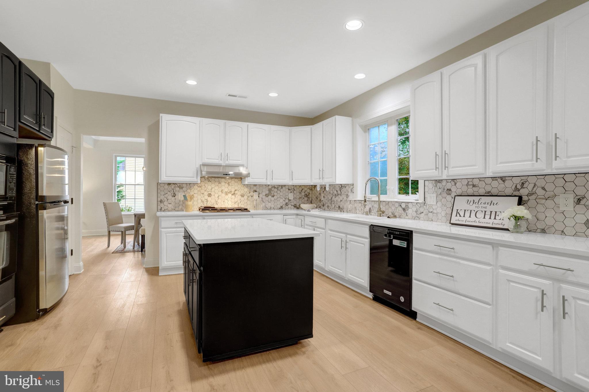 3905 Cook Street Alexandria, VA 22311 - Photo 3 of 39 a kitchen with kitchen island granite countertop a sink cabinets and stainless steel appliances