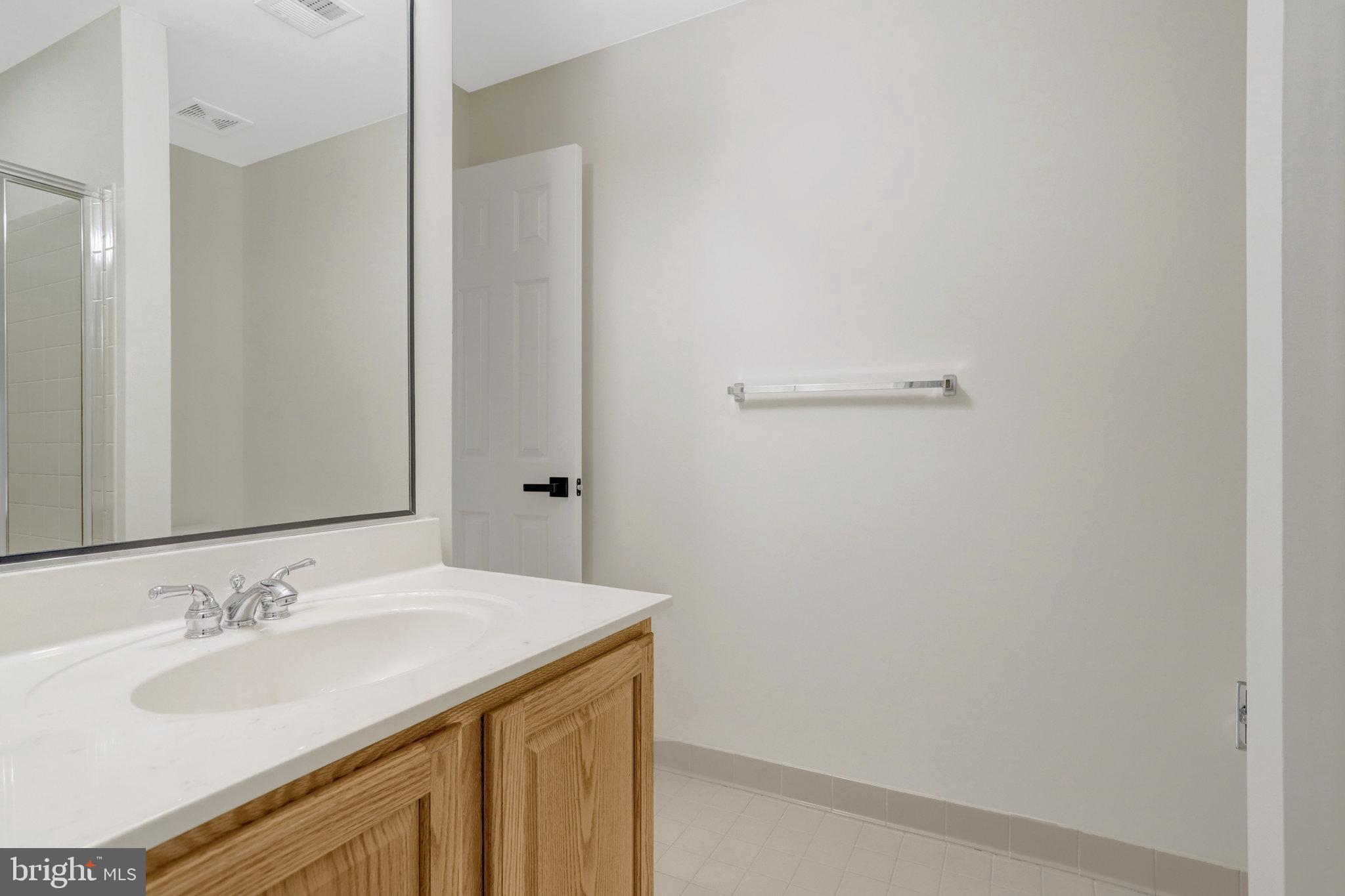 3905 Cook Street Alexandria, VA 22311 - Photo 35 of 39 a bathroom with a sink and a mirror