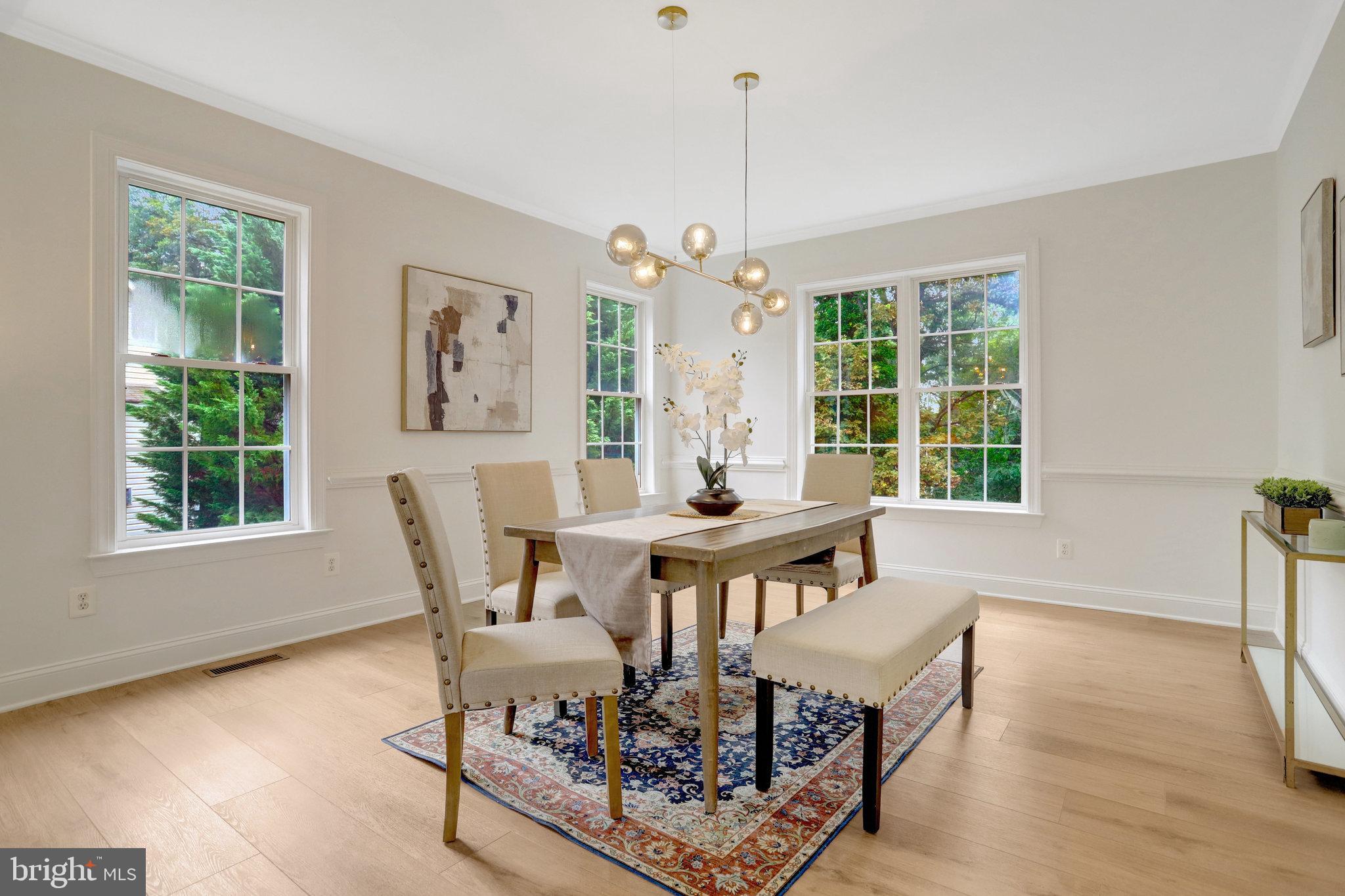 3905 Cook Street Alexandria, VA 22311 - Photo 10 of 39 a dining room with furniture a chandelier and wooden floor