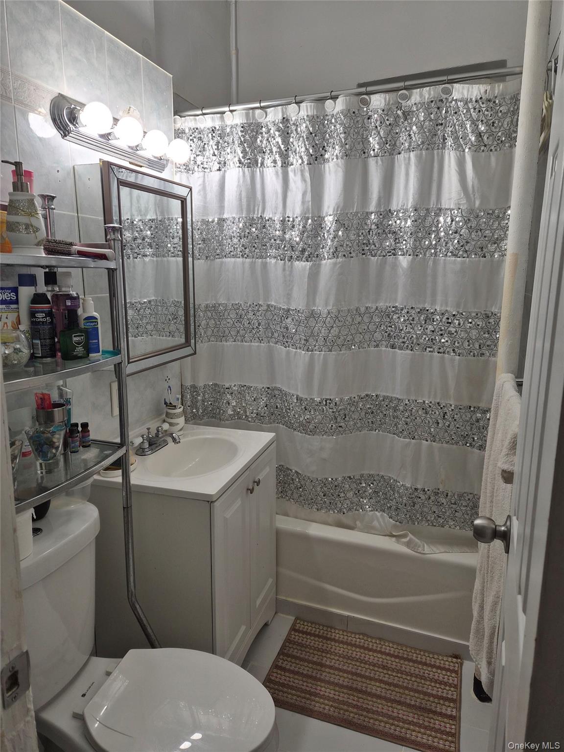37-21 80th Street, Unit 1R Queens, NY 11372 - Photo 3 of 5 a bathroom with a sink toilet and shower