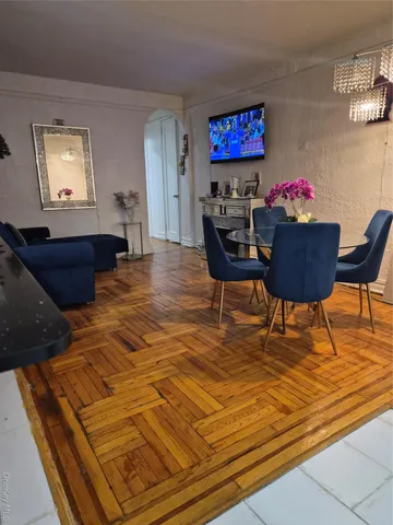 a living room with furniture and a dining table