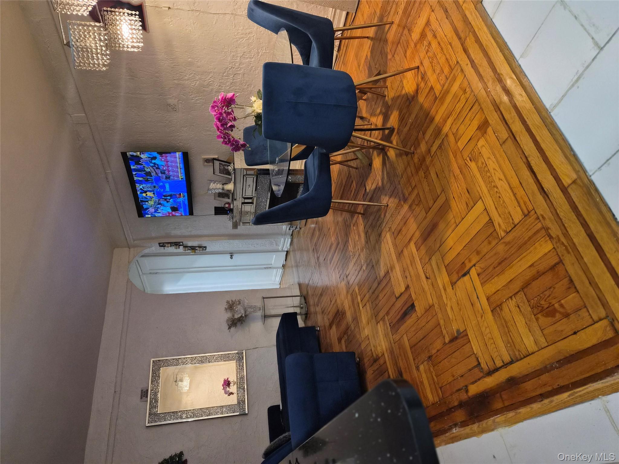 37-21 80th Street, Unit 1R Queens, NY 11372 - Photo 5 of 5 a living room with furniture and a dining table