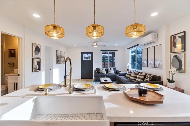 a living room with furniture a large window and a rug