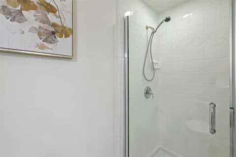 a bathroom with a glass shower door