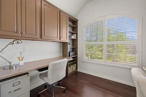 a kitchen with granite countertop cabinets stainless steel appliances a sink and a window