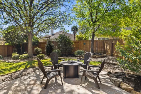a view of a chair and table in backyard