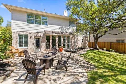 a view of a backyard with sitting area