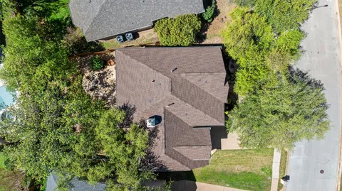 an aerial view of a house with a yard
