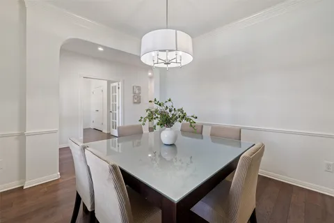 a view of a dining room with a table and chairs