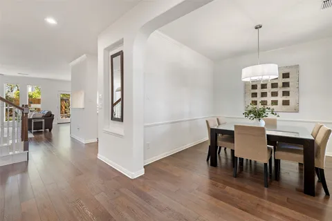 a view of a dining room with furniture wooden floor and a chandelier