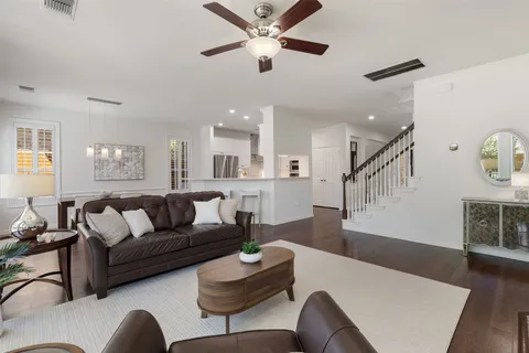 a living room with furniture and kitchen view