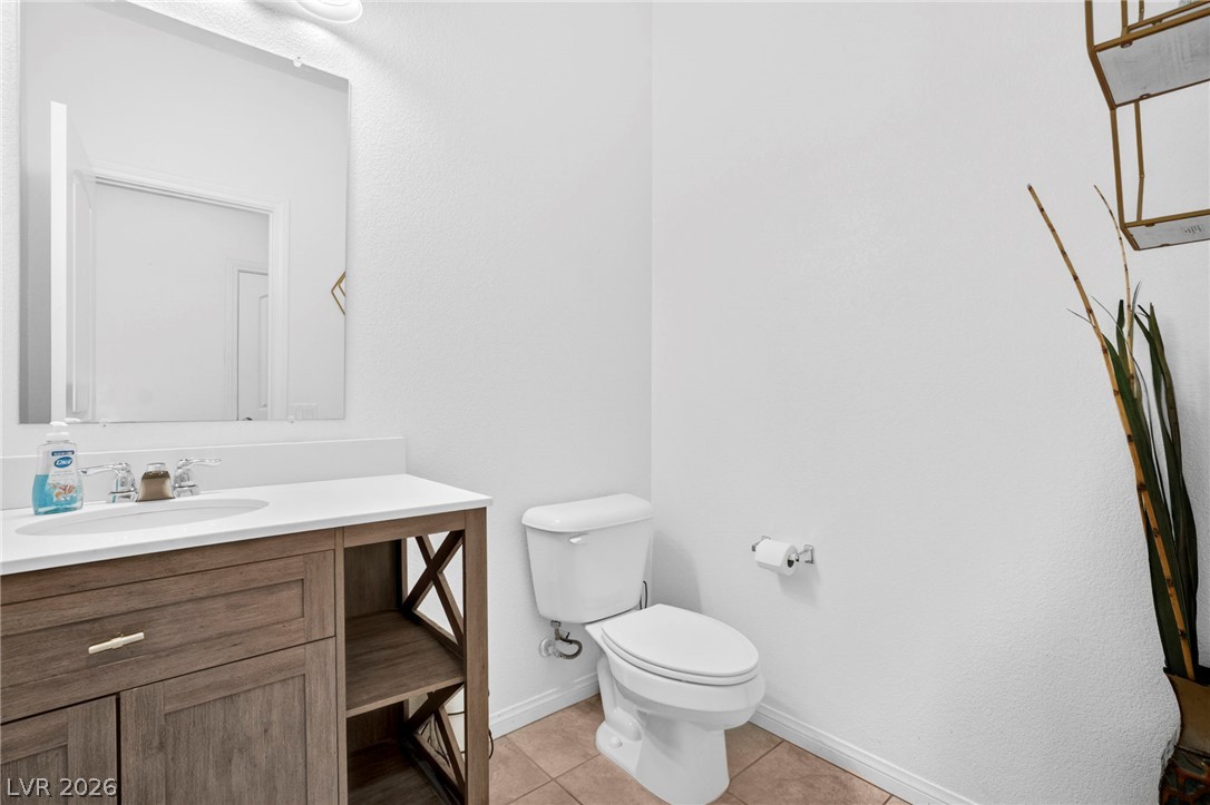 6281 Angora Peak Lane Las Vegas, NV 89115 - Photo 6 of 34 Clean lines define this powder room, featuring a modern vanity with ample storage.