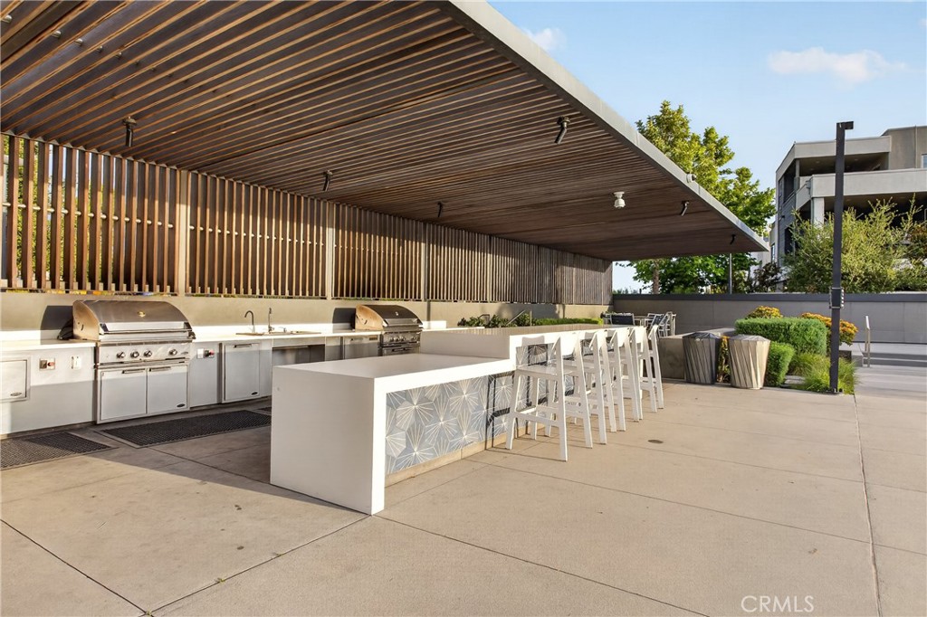 382 Chorus Irvine, CA 92618 - Photo 35 of 38 a view of a patio with table and chairs potted plants with wooden fence