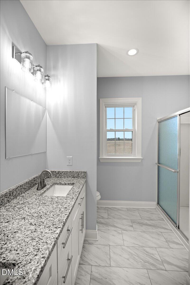 1300 Nick Coley Road Whitakers, NC 27891 - Photo 35 of 47 a bathroom with a granite countertop sink and a mirror