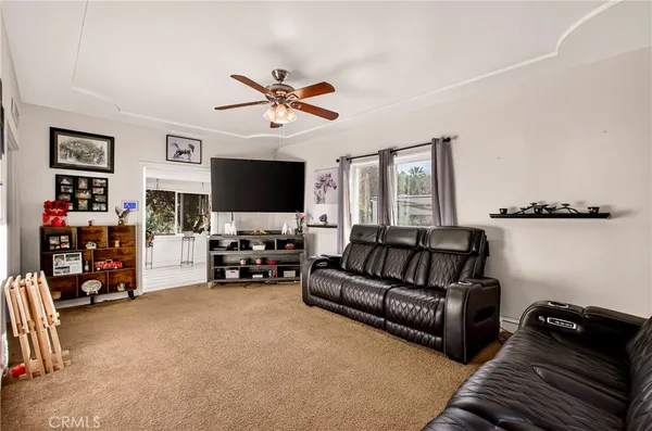 a kitchen with stainless steel appliances granite countertop a stove top oven a sink dishwasher a dining table and chairs with wooden floor