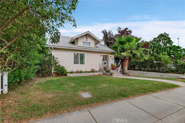 a front view of a house with a yard and a garage