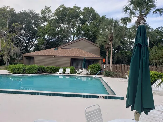a view of house with outdoor space and swimming pool