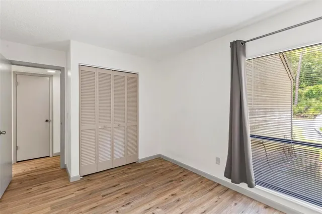 a view of wooden floor and windows in a room