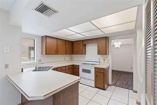 a kitchen with a sink a stove and cabinets