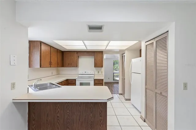 a kitchen with a stove a refrigerator and a sink