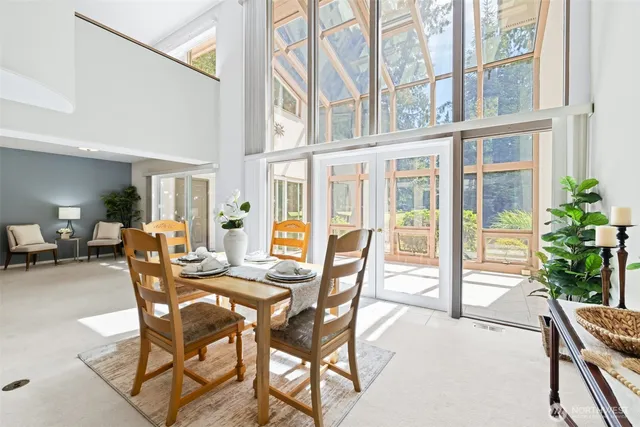 a dining room with furniture and glass door