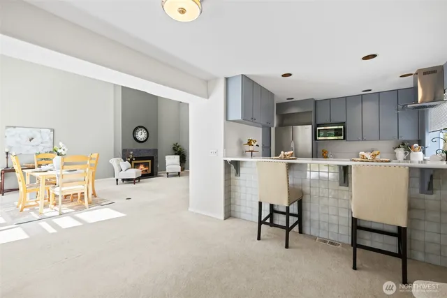 a living room with furniture and a dining table with kitchen view
