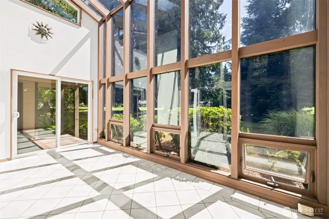 a view of a balcony with a large window and wooden floor
