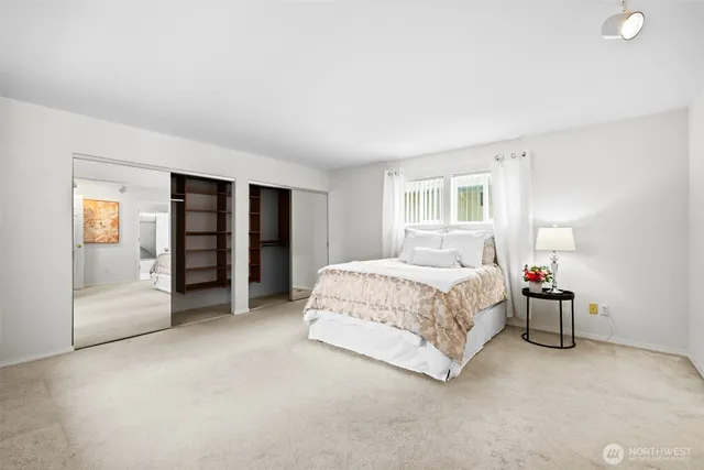 a spacious bedroom with a bed and a cabinets